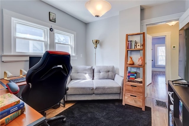 office space featuring visible vents and wood finished floors