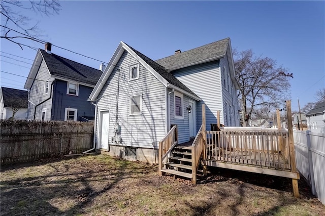 back of house featuring a wooden deck and fence private yard