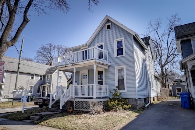 view of front of property with a porch and a balcony