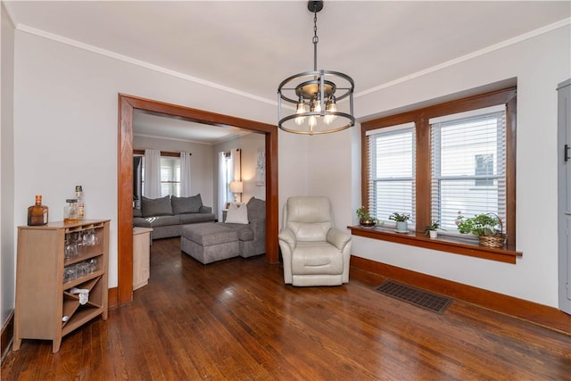 sitting room featuring visible vents, dark wood-type flooring, an inviting chandelier, and ornamental molding