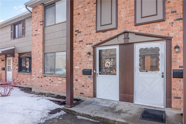 property entrance with brick siding