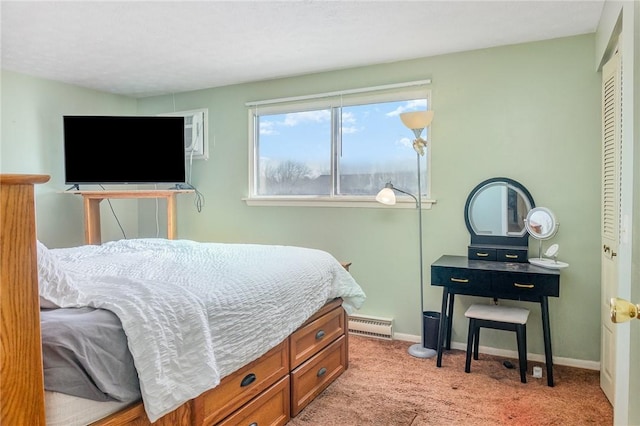 carpeted bedroom featuring baseboards and a baseboard radiator