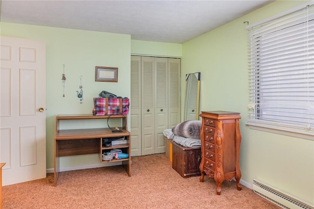 carpeted bedroom featuring a baseboard heating unit, multiple windows, baseboards, and a closet