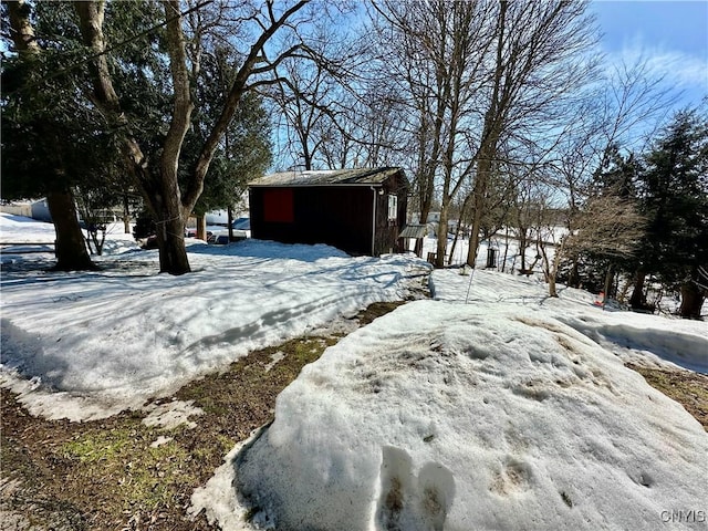 yard covered in snow with an outdoor structure