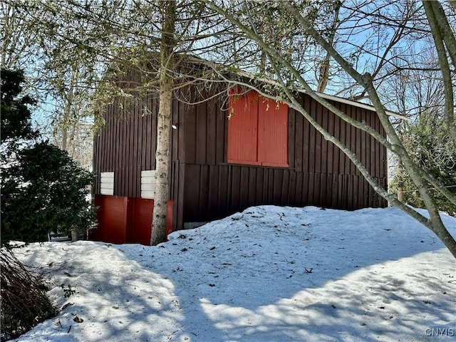 snow covered property with an outdoor structure