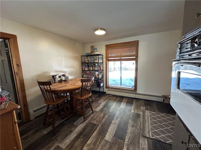 dining space with a baseboard heating unit and dark wood-style floors