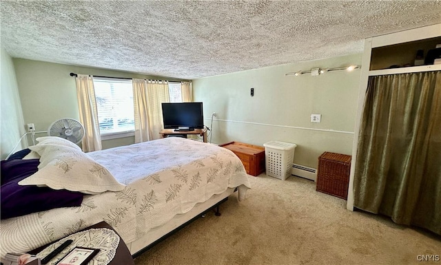 bedroom with carpet flooring, a textured ceiling, and a baseboard heating unit