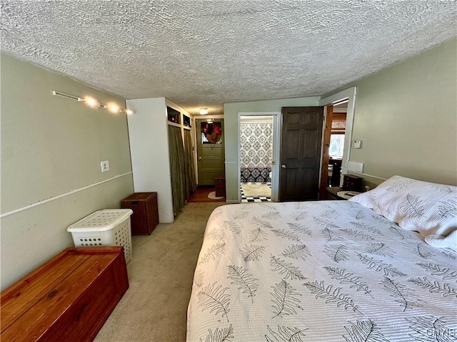 bedroom featuring light carpet and a textured ceiling