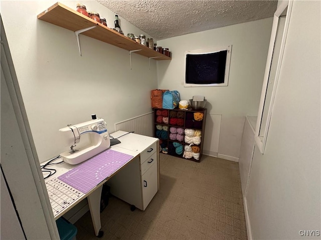 office space with tile patterned floors and a textured ceiling