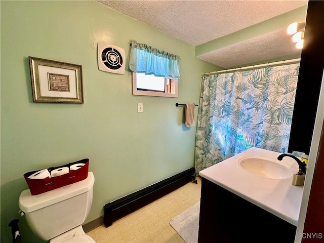 bathroom with baseboards, toilet, vanity, tile patterned floors, and a textured ceiling