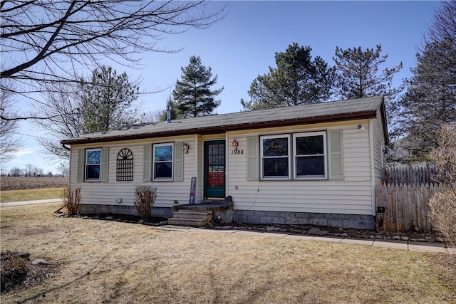 view of front of property with a front yard and fence