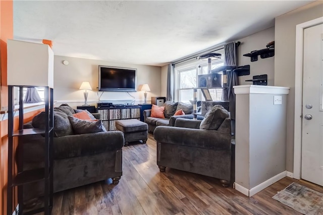 living area featuring baseboards and wood finished floors