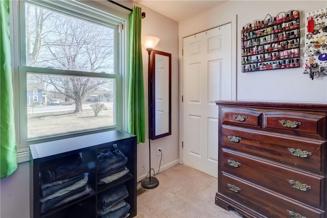 misc room with baseboards and light colored carpet