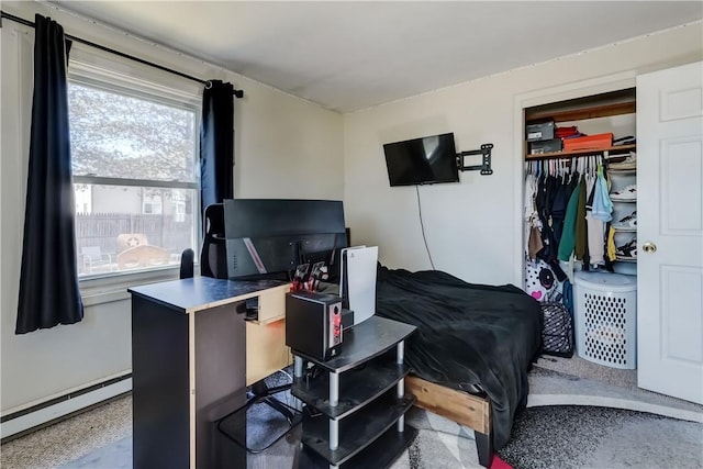 bedroom featuring a closet and baseboard heating