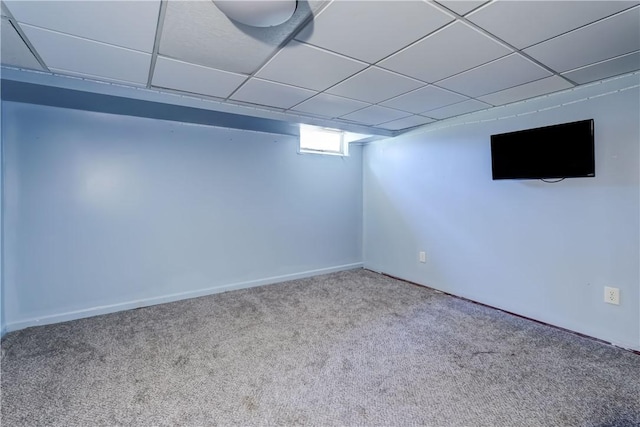 basement with a drop ceiling and carpet