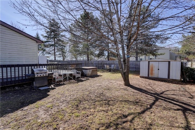 view of yard featuring a fenced backyard, an outbuilding, and a storage shed