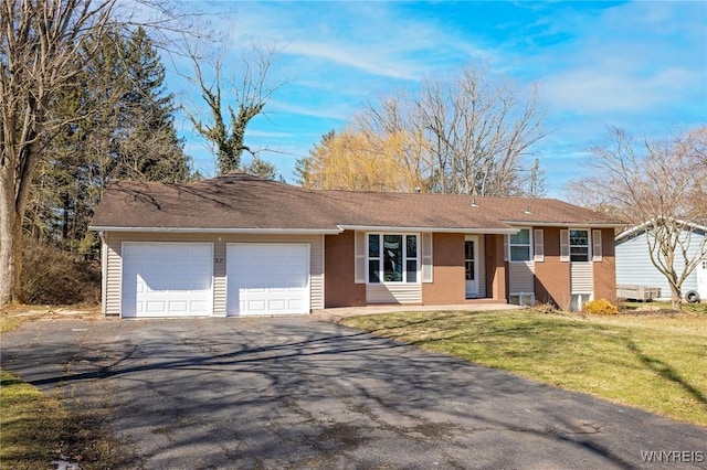 ranch-style house featuring aphalt driveway, a front yard, and a garage