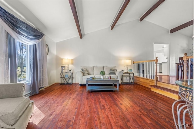 living room with stairway, lofted ceiling with beams, and wood finished floors