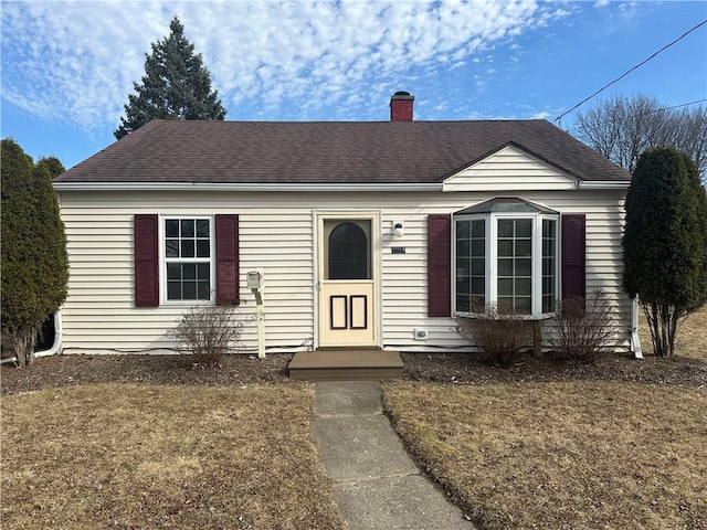 view of front of home featuring roof with shingles and a chimney