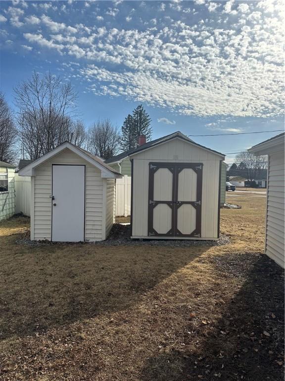 view of shed featuring fence