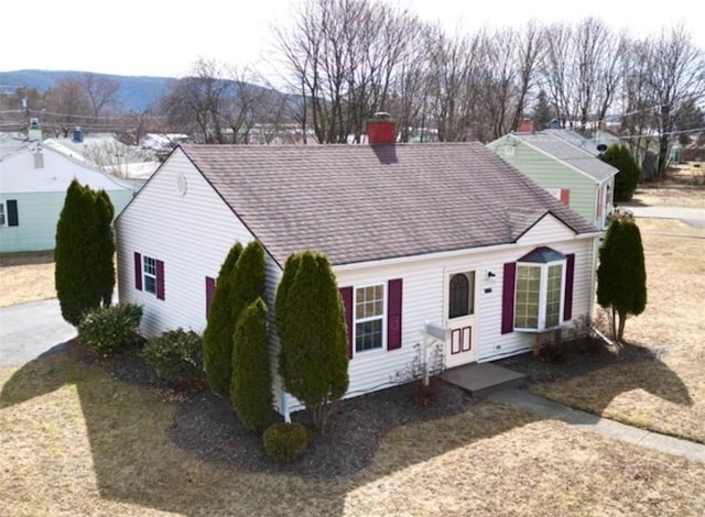 view of front facade with roof with shingles