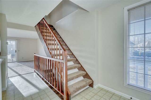 stairs featuring baseboards