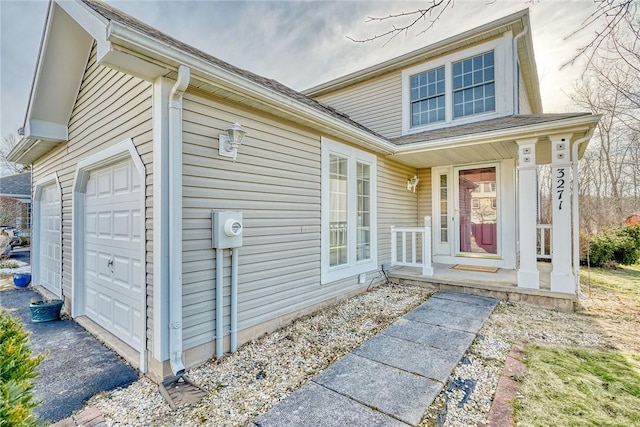 property entrance with a porch and an attached garage