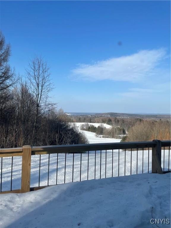 view of snow covered back of property