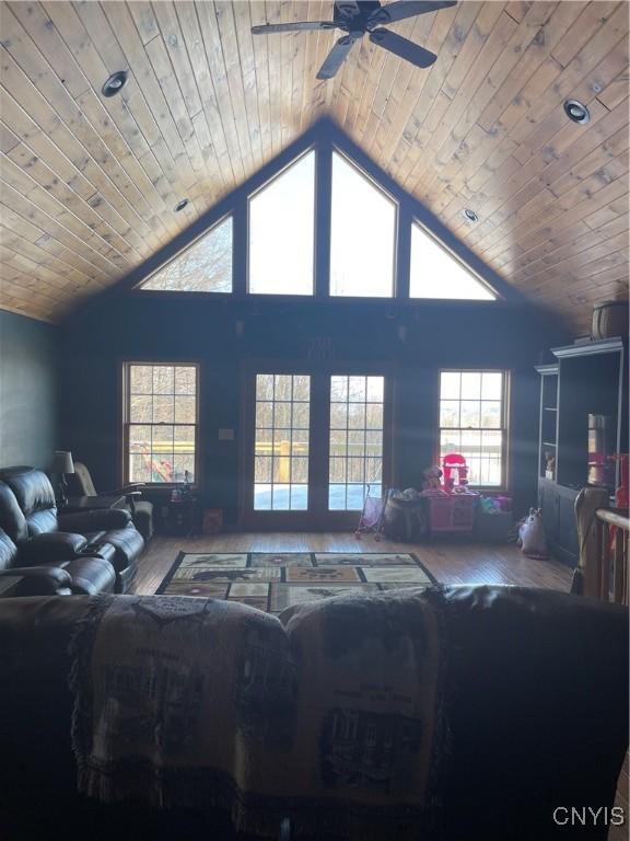 living area featuring wooden ceiling, high vaulted ceiling, a ceiling fan, and wood finished floors