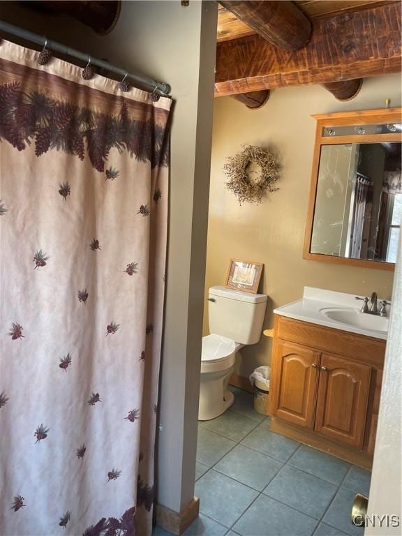 full bath with tile patterned floors, beam ceiling, toilet, baseboards, and vanity