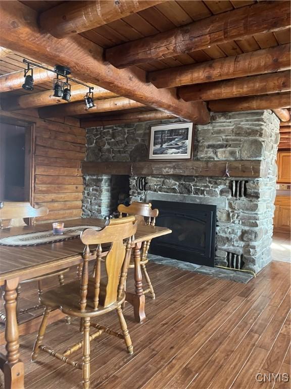 8558 Jackson Hill Rd, Boonville, NY 13309 - dining area featuring beamed ceiling, wood ceiling, wood finished floors, and a fireplace