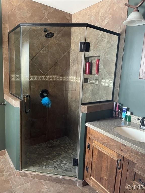 bathroom featuring a stall shower and vanity