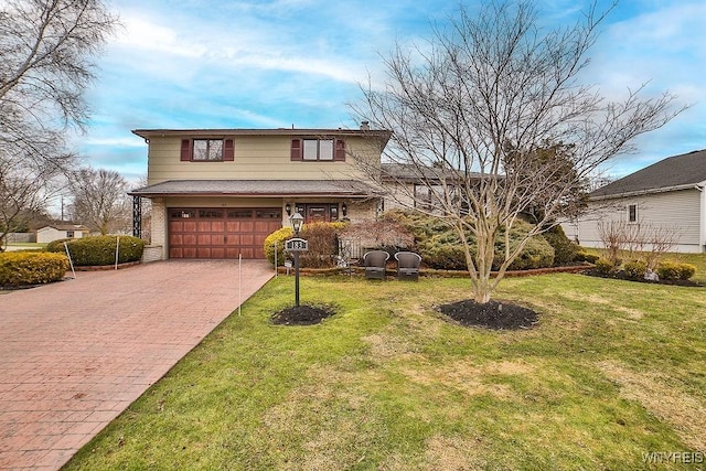 traditional home with brick siding, decorative driveway, a front yard, and an attached garage