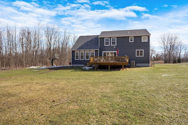 back of property with central AC unit, a lawn, roof with shingles, and a wooden deck