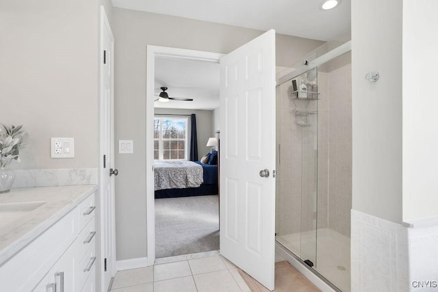 ensuite bathroom with tile patterned flooring, a stall shower, vanity, and ensuite bathroom