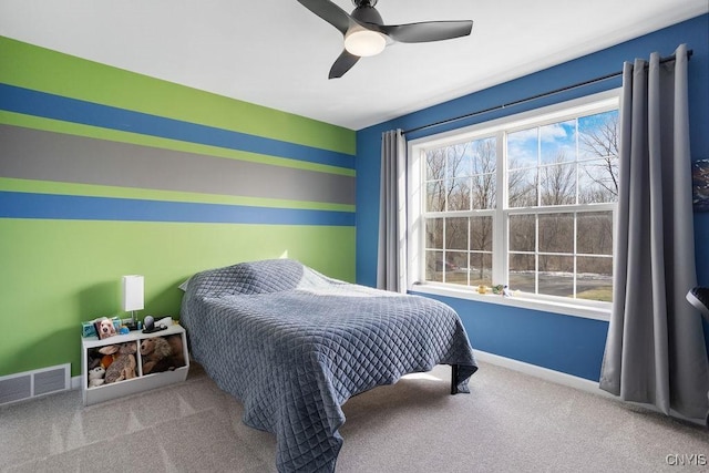 carpeted bedroom with baseboards, visible vents, and ceiling fan