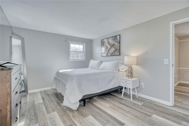 bedroom featuring baseboards and light wood-style floors