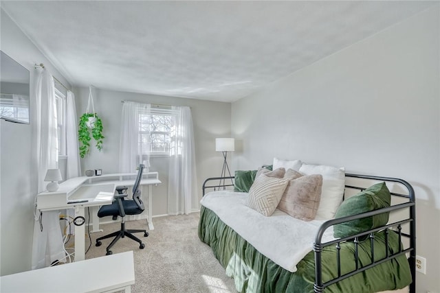 bedroom featuring baseboards and light carpet