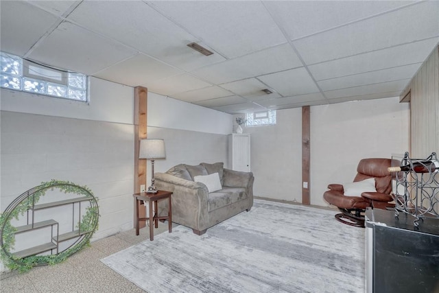 living area with visible vents and a paneled ceiling