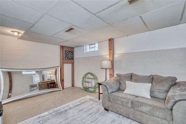 living area with a drop ceiling