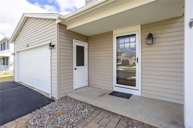 property entrance with driveway and a garage