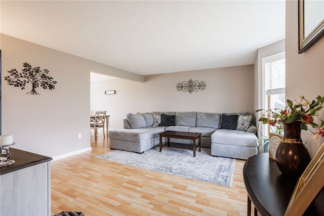 living area with light wood finished floors and baseboards