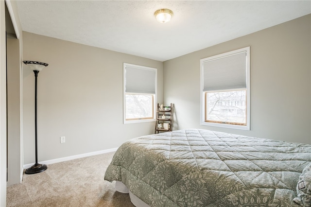 carpeted bedroom with baseboards