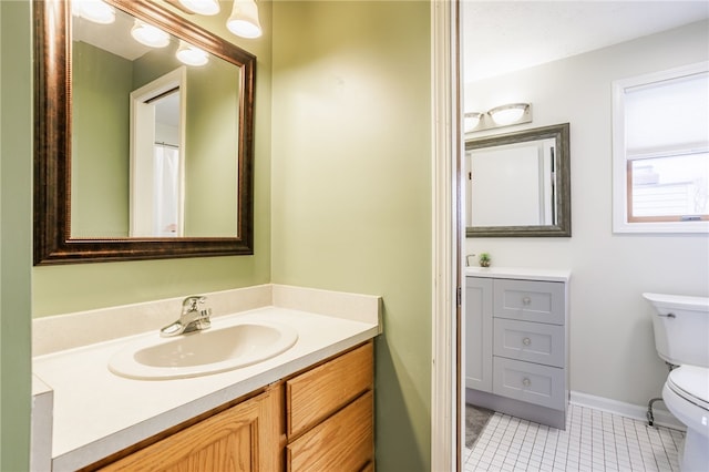 full bathroom with tile patterned floors, toilet, vanity, and baseboards