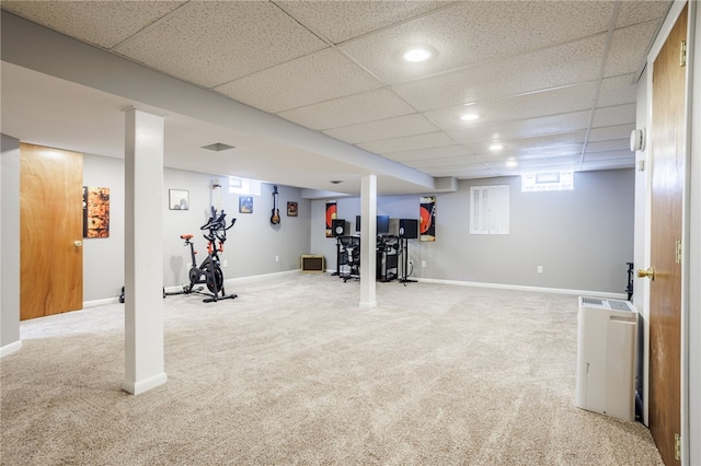 workout room featuring a paneled ceiling, baseboards, and carpet floors