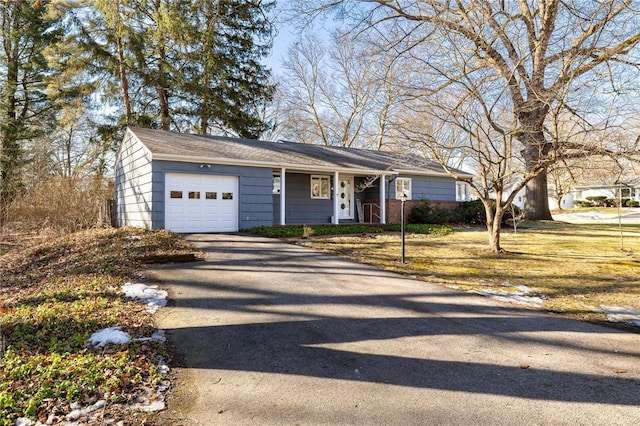 single story home with driveway and a garage