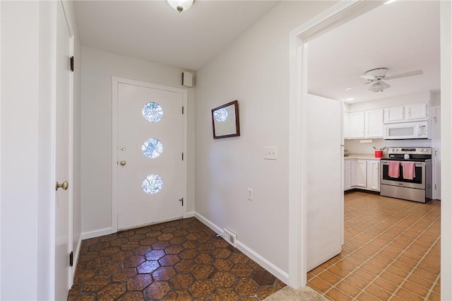 entrance foyer with visible vents, a ceiling fan, and baseboards