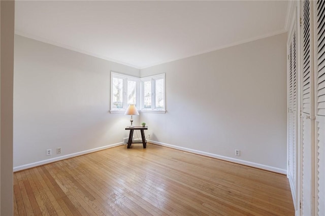 unfurnished bedroom with baseboards, light wood-style floors, and crown molding