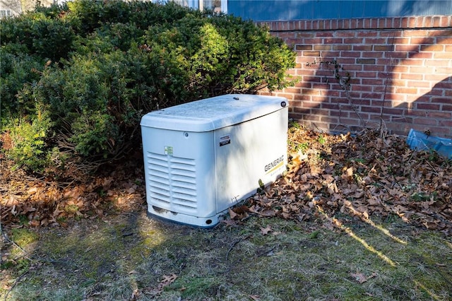 exterior details featuring a jacuzzi, a power unit, and brick siding