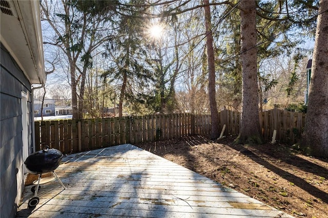 deck featuring a grill and a fenced backyard